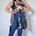 Woman wearing a plus-size sheer mesh sleeveless top with a high front split in a palm beach style.