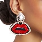 old teardrop-shaped earrings with rhinestone-encrusted lips design.