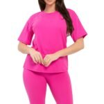 Model wearing a bright fuchsia brushed DTY round neck tee and high-waisted biker shorts set, showcasing the comfortable fabric.