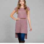 Woman wearing a Burgundy High Low Tunic Top with short sleeves and a round neck, showcasing the flattering, flowy high-low hem.
