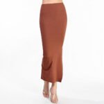 Full-length view of a Pine Cone Long Maxi Skirt featuring a high-waisted fit and a sophisticated side slit. The close-up detail highlights the unique textured jacquard rib knit fabric in a rich earth tone, offering a blend of comfort and chic modern style.