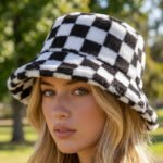A women's structured bucket hat made of soft, warm black and white checkered plush material.