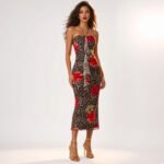 A floor-length power mesh women's halter maxi dress featuring a bold leopard and red hibiscus floral print, neck tie, front drape detail, and a fitted mermaid silhouette.