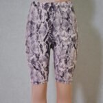 Woman wearing tan brown snakeskin print biker shorts with high stretch fabric, available in regular and plus sizes S-3X.