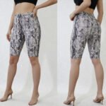 Woman wearing tan brown snakeskin print biker shorts with high stretch fabric, available in regular and plus sizes S-3X.
