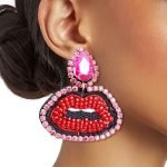 Pink teardrop earrings with rhinestones and black red embroidered lips detail, 2 inches wide.