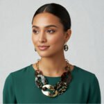 Women's jewelry set featuring a leopard print acetate oval link necklace with gold-tone chain and matching 1.5-inch drop earrings.