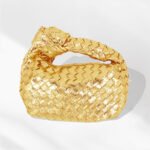 Elegant gold woven knotted handbag, a chic accessory for a sophisticated look.