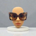 Women's fashion sunglasses featuring a bold tortoise shell oversized cat-eye frame with dark lenses and a vintage-inspired silhouette.