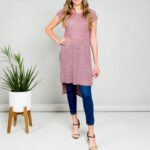 Woman wearing a Burgundy High Low Tunic Top with short sleeves and a round neck, showcasing the flattering, flowy high-low hem.