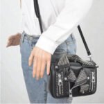 Edgy small statement handbag with metal studded jacket detailing, perfect as a night-out clutch or evening bag for women.