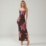 Woman wearing a sleeveless bodycon maxi dress in a Downtown Brown Lily floral print, featuring a square neckline, side slit, and an intricate layered strap open-back detail.